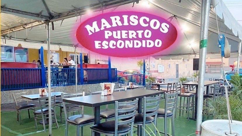 Colorful seafood restaurant dining room with tropical decor.