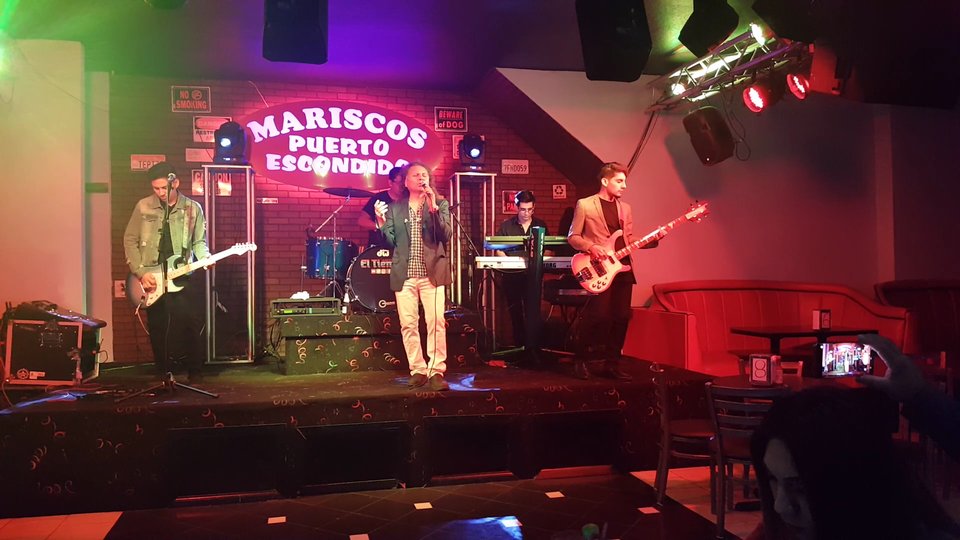 Live music stage beside restaurant seating.