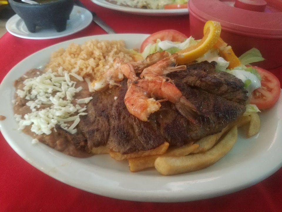 Restaurant menu featuring caldos and camarones.