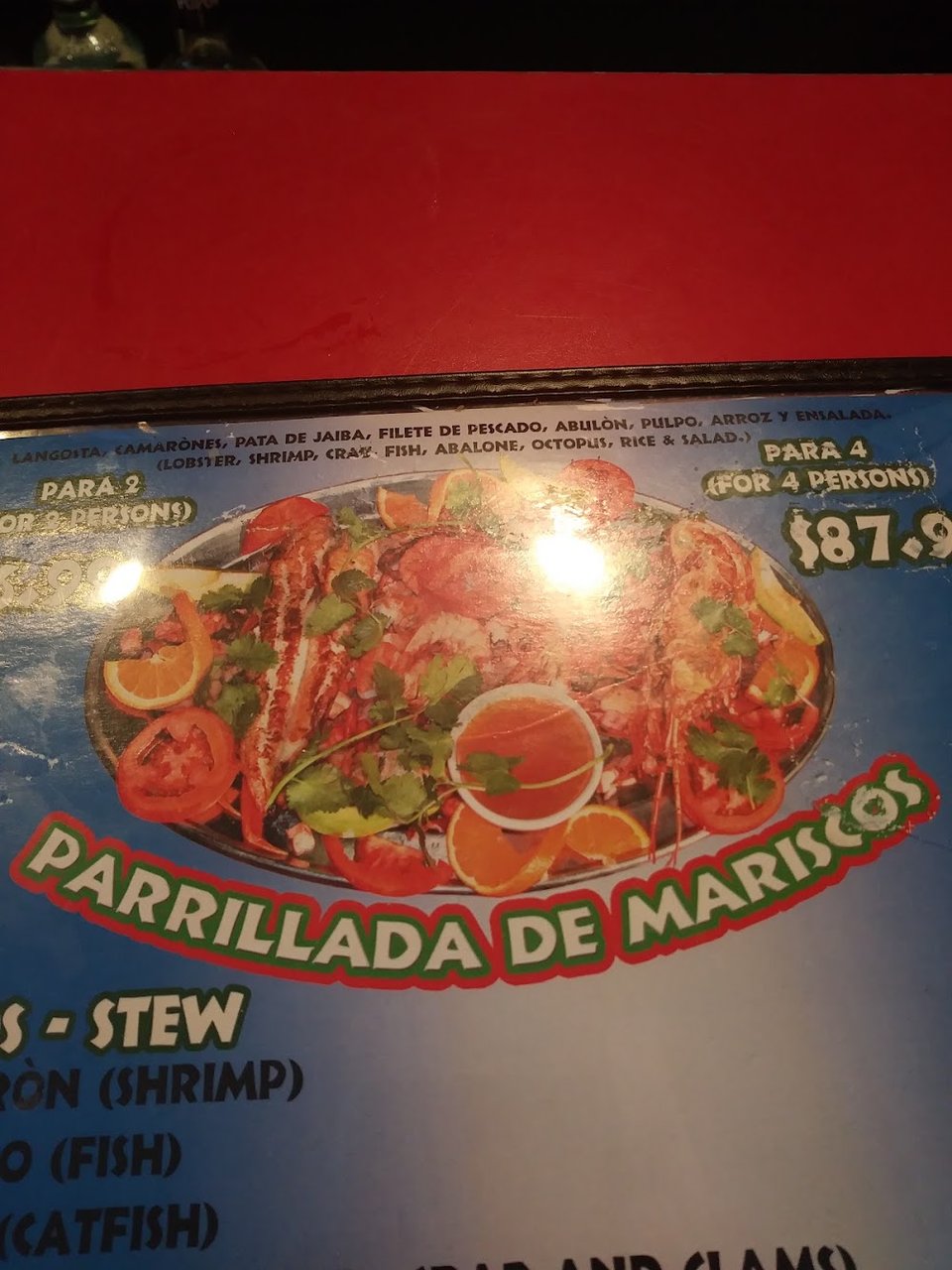 Menu layout highlighting seafood, meat, and filete plates.
